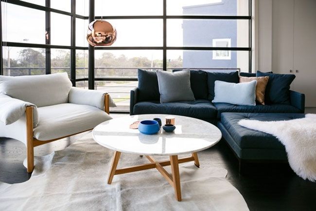 salón-blanco-paredes-cristal-sofá-azul-