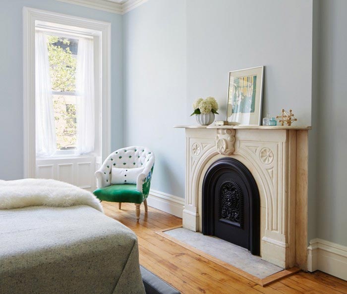 dormitorio-con-chimenea-butaca-blanca-y-verde