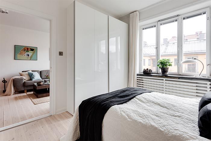 dormitorio-blanco-estilo-nordico-mueble-puertas-lacadas-blancas